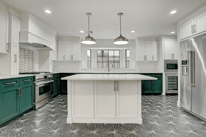 Kitchen renovation with green cabinets and white countertops in Houston